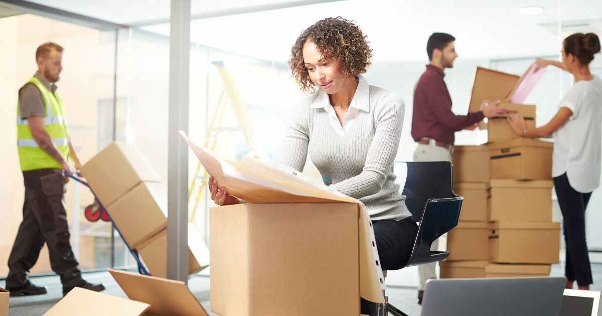 A group of people are moving into a new office.